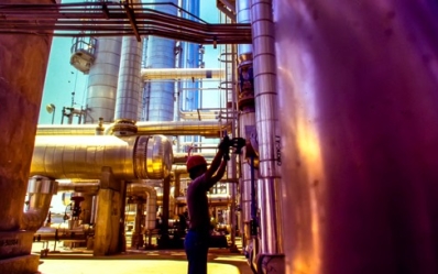 power plant worker inspecting steel pipelines